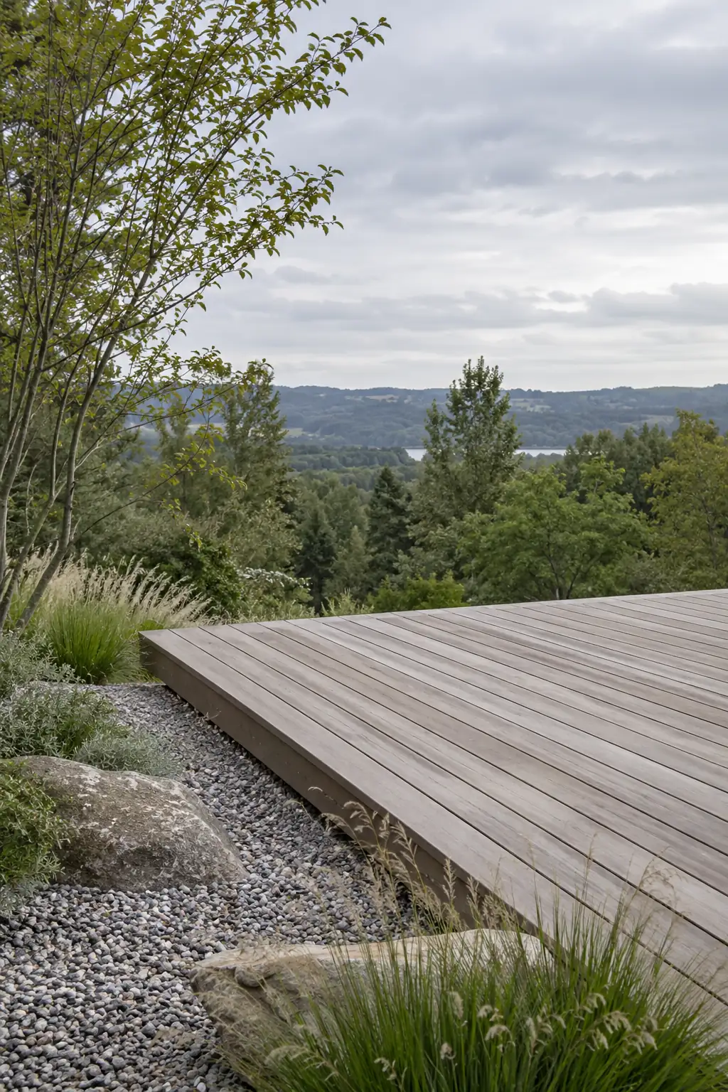 Deck platform reaching from a garden toward trees on an overcast day